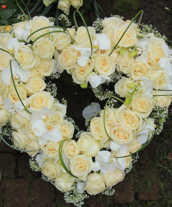Heart,Shaped,Sympathy,Or,Funeral,Flowers,Near,A,Tree,At